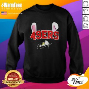 Official San Francisco 49ers X Snoopy Happy Easter Sweatshirt featuring Snoopy in a festive design with team colors.