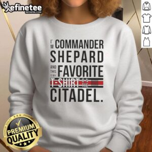 Alt Text: Commander Shepard wearing 'Awesome I'm Commander Shepard' sweatshirt on the Citadel, showcasing iconic Mass Effect style.