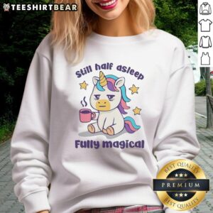 Alt Text: Top unicorn holding a coffee mug, looking sleepy in a magical sweatshirt, perfect for cozy mornings.