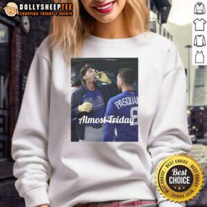 Alt Text: Jac Caglianone of the Kansas City Royals sipping espresso in dugout zone, wearing Almost Friday sweatshirt.