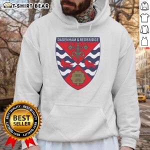 Alt Text: Top Dagenham and Redbridge FC logo 1881 hoodie featuring vibrant club colors and emblem for fans.