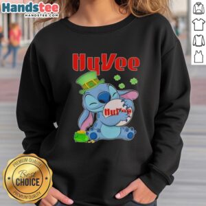 Alt Text: Cute Stitch hugging Hy-Vee logo on a St. Patrick's Day sweatshirt, perfect for festive celebrations and cozy wear.