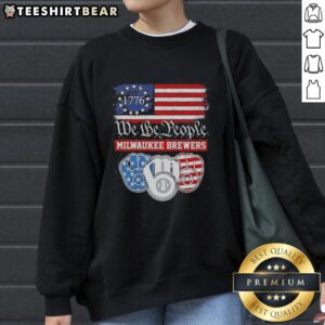 Alt Text: Milwaukee Brewers sweatshirt featuring 'We The People' and 'American Since 1776' designs, perfect for fans.