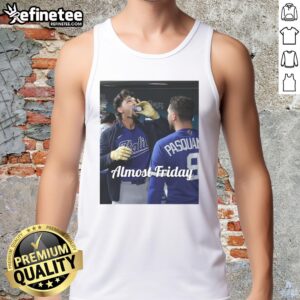 Alt Text: Jac Caglianone of the Kansas City Royals enjoying espresso in dugout zone, wearing Almost Friday tank top.