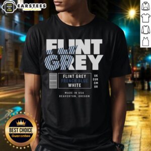 Good Flint Grey French Blue White Label T-Shirt displayed on a wooden surface, showcasing its stylish design and fabric.