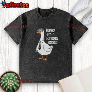 Alt Text: Top Goose wearing a 'Today I'm a Serious Goose' washed t-shirt while holding a backpack, showcasing a playful style.