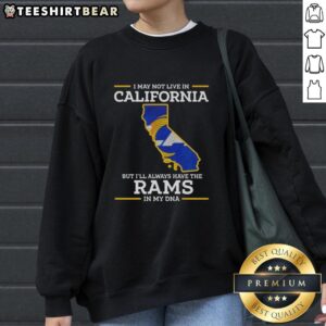 Cozy sweatshirt featuring 'I may not live in California but Ill always have the Los Angeles Rams in my DNA' design.