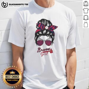Stylish Atlanta Braves girl in a messy bun wearing glasses and a team t-shirt, perfect for game day fashion.