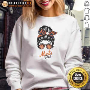 Girl in a messy bun and glasses wearing a New York Mets sweatshirt, showcasing team spirit and casual style.