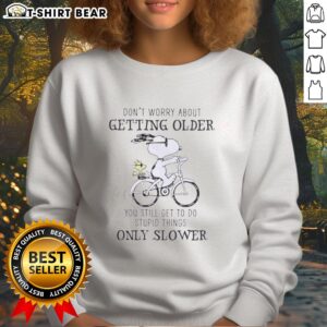 Original Peanuts Snoopy sweatshirt with humorous quote about aging and doing dumb stuff, featuring Snoopy design.