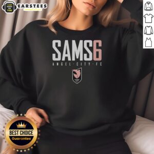 Emily Sams wears an Awesome Sams 6 sweatshirt featuring the Angel City FC logo, showcasing team spirit and style.