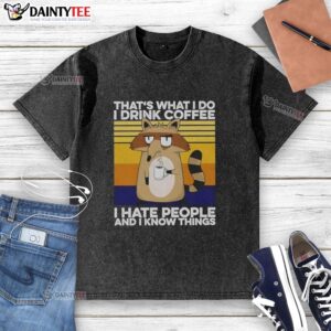 Grumpy raccoon on a 'That's What I Do, I Drink Coffee' washed t-shirt, perfect for coffee lovers and animal enthusiasts.