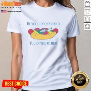 Alt Text: Woman holding a nice hotdog in one hand and a drink in the other while wearing a stylish ladies tee.
