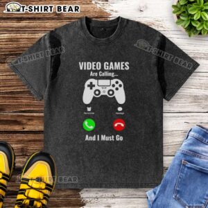 Top Video Games Are Calling And I Must Go Console Washed T-Shirt displayed on a hanger, showcasing its vibrant design and casual style.