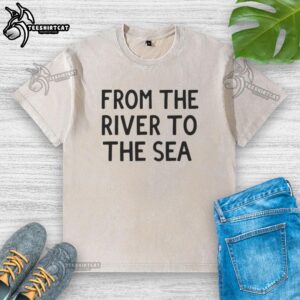 Nice From The River To The Sea washed t-shirt displayed on a wooden background, showcasing its soft fabric and vibrant print.