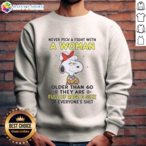 Funny Snoopy sweatshirt: 'Never pick a fight with a woman over 60' - perfect for humor lovers and Peanuts fans!