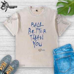Pretty Ball Better Than You washed t-shirt displayed on a hanger, showcasing its vibrant design and soft fabric.