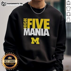Man wearing a Nice High Five Michigan Wolverines sweatshirt, showcasing team spirit and style at a game.