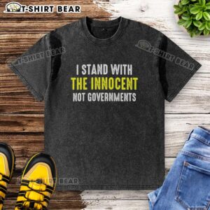 Official I Stand With The Innocent Not Governments washed t-shirt displayed on a hanger, promoting social justice awareness.
