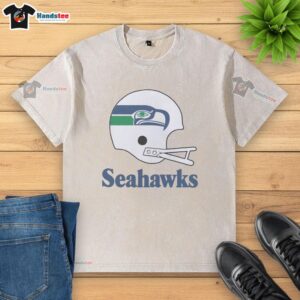 Alt Text: Awesome Seattle Seahawks football logo displayed on a big helmet graphic on a washed t-shirt.