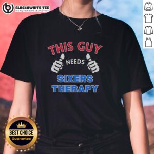 Official Philadelphia 76ers 'This Guy Needs Sixers Therapy' ladies tee showcasing team spirit and humor for fans.