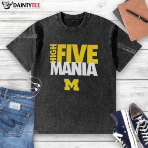 Man wearing a Michigan Wolverines washed t-shirt giving a high five, showcasing team spirit and game day excitement.