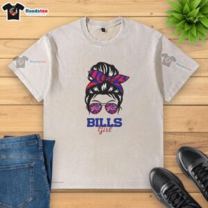 Buffalo Bills girl in a messy bun and glasses wearing a washed t-shirt, showcasing team spirit and casual style.
