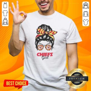 Alt Text: Girl wearing a Kansas City Chiefs t-shirt with a messy bun and glasses, showcasing team spirit and style.