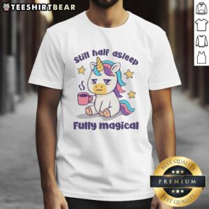 Top unicorn holding a coffee mug, looking half asleep, on a fully magical t-shirt design.