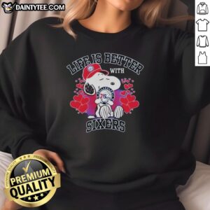 Snoopy wearing a Philadelphia 76ers logo sweatshirt with 'Life Is Better With Sixers' slogan, perfect for fans.