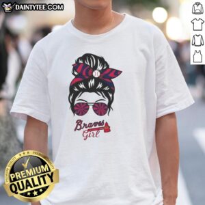 Good Atlanta Braves girl wearing a messy bun and glasses, sporting a stylish Braves T-shirt for game day.