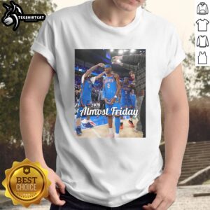 Alt Text: Original Shai Gilgeous-Alexander Oklahoma City Thunder Almost Friday Postgame T-Shirt featuring team logo and vibrant design.