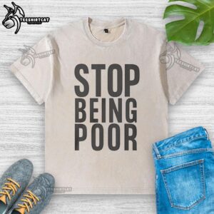 Official Stop Being Poor washed t-shirt featuring bold text design, perfect for casual wear and statement fashion.