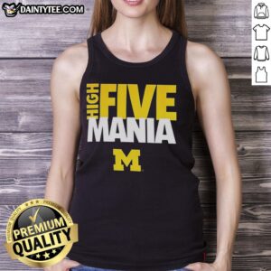 Man wearing a Michigan Wolverines tank top celebrating with a high five at a sports event, showcasing team spirit.