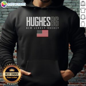 Jack Hughes wearing a New Jersey Devils hoodie with USA flag design, showcasing team spirit and style.