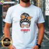 Girl in messy bun wearing Kansas City Chiefs glasses t-shirt, perfect for game day and showing team spirit.