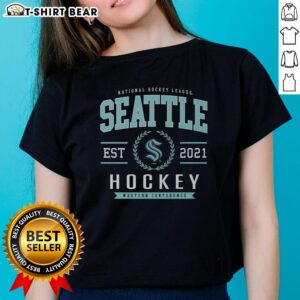 Alt Text: Hot Seattle Kraken Hockey Legacy Crest Ladies Tee featuring team colors and logo on a stylish women's shirt.