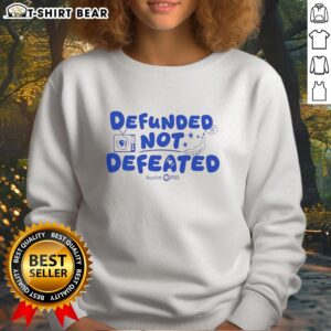 Good Defunded Not Defeated Austin PBS slogan sweatshirt displayed in vibrant colors, promoting community support.