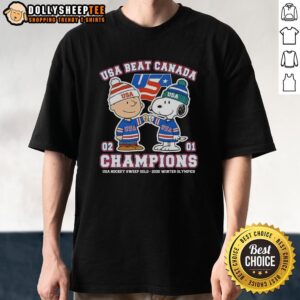 Charlie Brown and Snoopy fist bump on USA Hockey 2026 Winter Olympics gold champions T-shirt, celebrating victory over Canada.