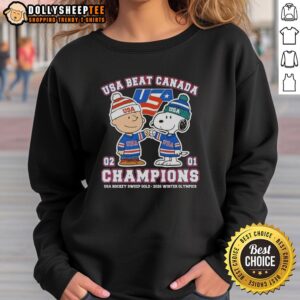 Charlie Brown and Snoopy celebrate USA Hockey's gold medal win against Canada at the 2026 Winter Olympics sweatshirt design.