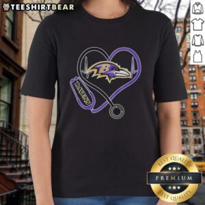 Top Nurse Heartbeat X Baltimore Ravens Logo Ladies Tee in purple, perfect for Ravens fans and healthcare professionals.