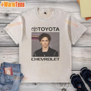 Actor wearing a washed t-shirt next to a nice car brand, showcasing style and automotive luxury.