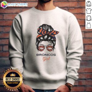 Denver Broncos girl with messy bun and glasses wearing a cozy sweatshirt, showcasing team spirit and style.