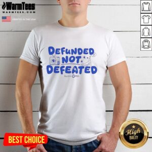 Premium Defunded Not Defeated Austin PBS slogan T-shirt showcasing bold text design on a stylish fit.