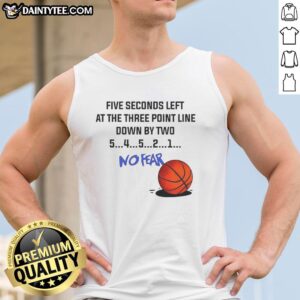 Man wearing 'No Fear' tank top shoots a three-pointer with five seconds left, down by two points in a basketball game.