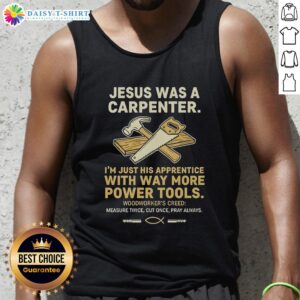 Man wearing 'Awesome Jesus Was A Carpenter' tank top, showcasing his love for woodworking and powerful tools in a workshop.