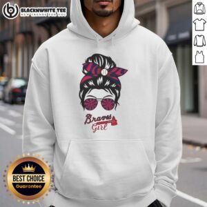 Girl in a messy bun wearing glasses and an Atlanta Braves hoodie, showcasing team spirit and casual style.