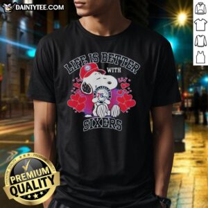 Alt Text: Snoopy wearing a Philadelphia 76ers logo shirt with Life Is Better With Sixers slogan, showcasing team spirit.