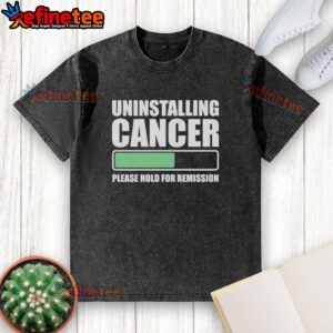 Unique 'Uninstalling Cancer, Please Hold for Remission' washed t-shirt design promoting cancer awareness and hope.