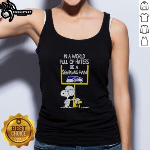 Alt Text: Premium Snoopy tank top featuring In A World Full Of Haters, Be A Seahawks Fan design for sports enthusiasts.